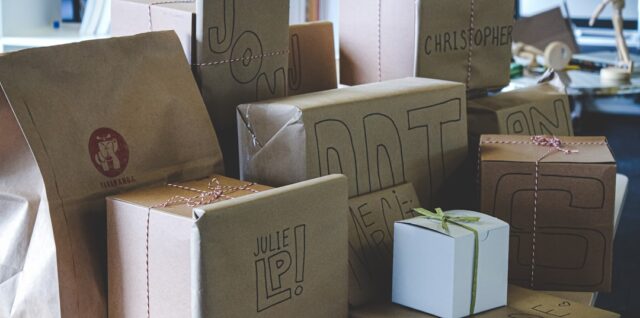 a pile of brown paper bags sitting on top of a table
